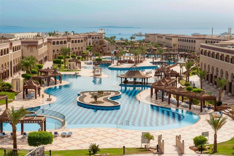 A Swimming Pool With A Large Pool Surrounded By Buildings