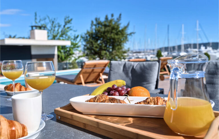 A Plate Of Food And A Glass Of Juice On A Table