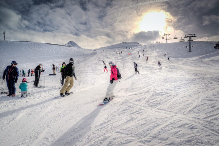 A Group Of People Skiing On A Snowy Hill